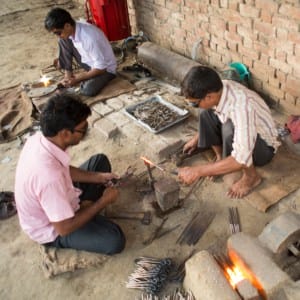 Dilshad Hussain and his team work on a piece of metal.