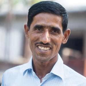 Khalil Ahmed, a smiling man in a blue shirt.
