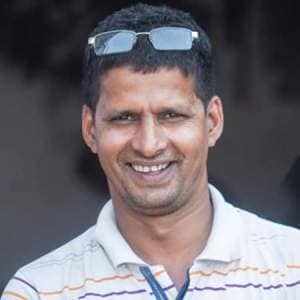 A smiling man wearing sunglasses and a polo shirt named Khalil Ahmed.