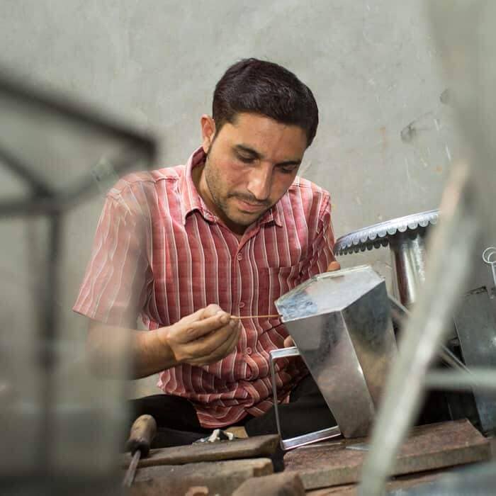 Anwar Saleem is working on a machine. Anwar Saleem is working on a machine.