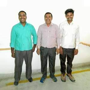 Three men from an electroplating team standing next to each other in a room.