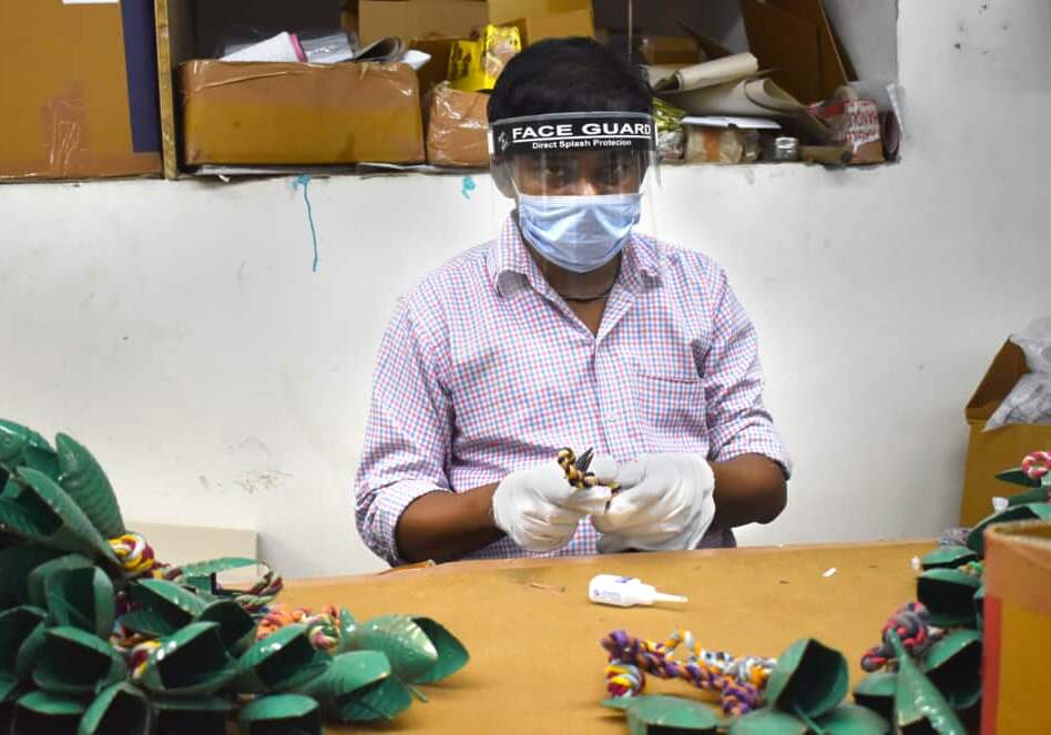 A masked worker faces the COVID challenge in a factory.